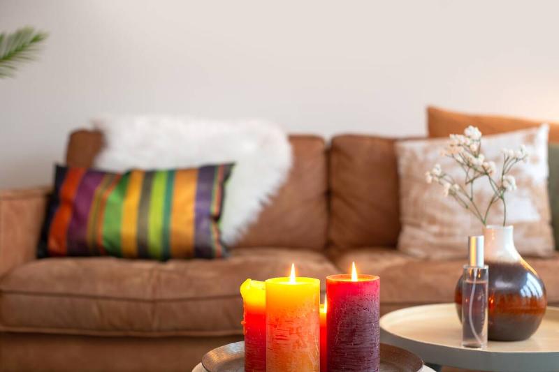 bright-colorful-interior-living-room-with-sofa-on-2025-10-16-09-24-21-utc Candles lit in living room.