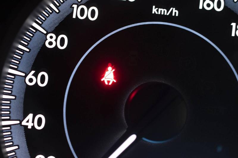 car-dashboard-showing-the-seat-belt-warning-light-2024-10-18-05-54-46-utc Car dashboard showing the seat belt warning light icon.