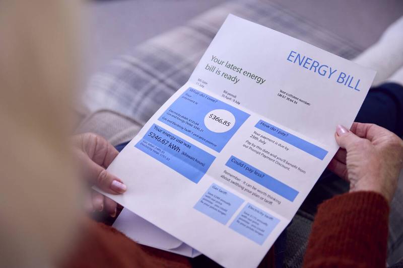 close-up-of-senior-woman-at-home-looking-at-usa-en-2024-10-20-22-47-08-utc Man looking at high energy bill.