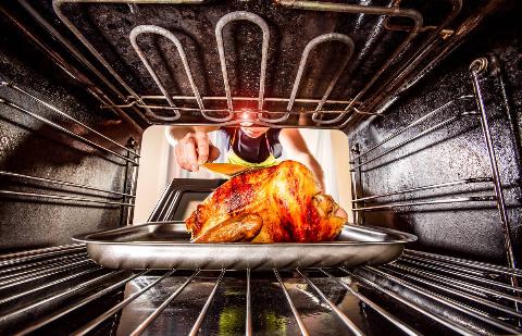 A turkey cooking in an oven.