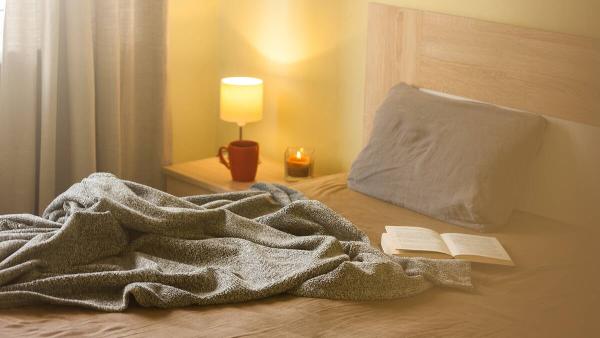 A bedroom with warm lighting.