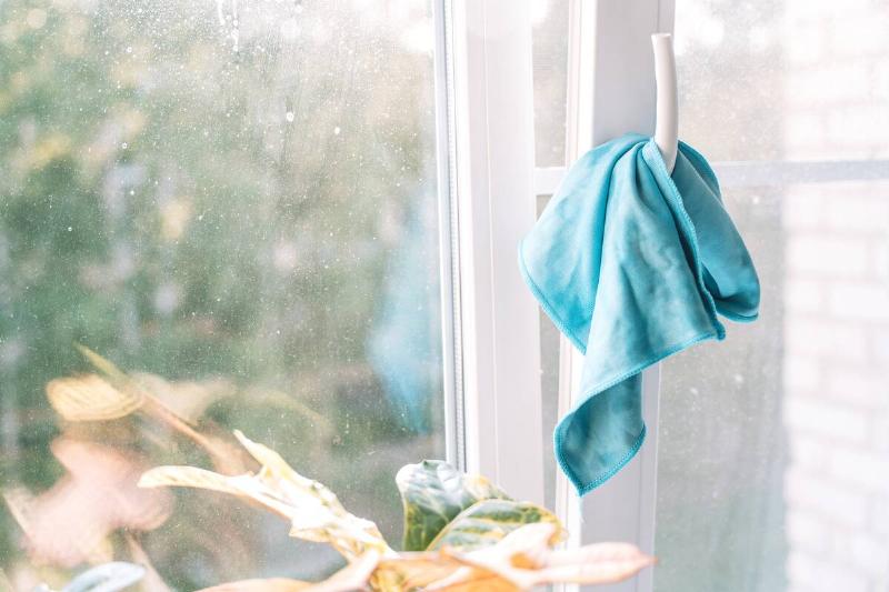 detail-of-a-damp-microfiber-cloth-placed-on-a-wet-2025-07-27-05-23-15-utc Microfiber cloth hanging on a window.
