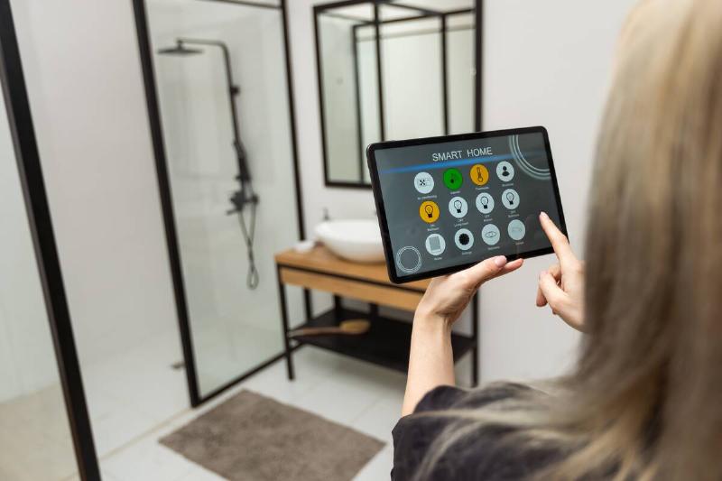 female-hands-holding-digital-tablet-with-smart-hom-2025-01-08-03-41-32-utc Woman using tablet for shower.