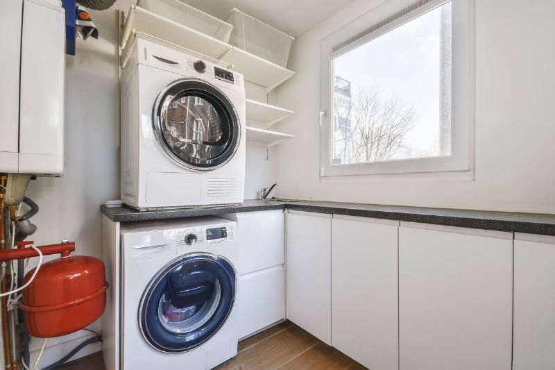 general-view-of-the-laundry-room-2025-02-09-22-36-26-utc A stacked washer and dryer.