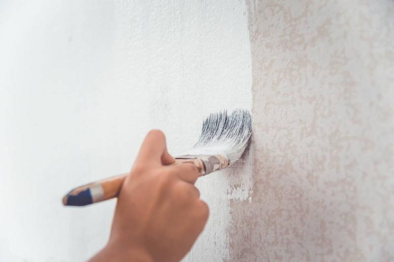 hand-was-holding-a-brush-to-paint-the-wall-using-w-2025-02-12-04-58-19-utc Painting a dirty wall.