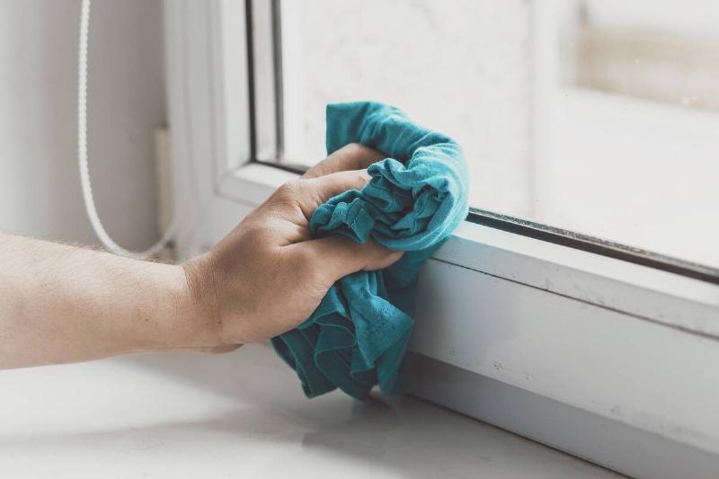 man-doing-chores-man-s-hand-cleaning-windowsill-w-2025-01-08-08-54-44-utc Man cleaning the windowsill with a blue cloth.