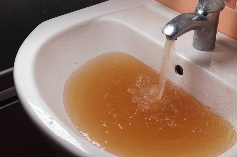rusty-water-pours-from-tap-water-pollution-globa-2025-02-25-12-26-59-utc Rusty water in bathroom sink.