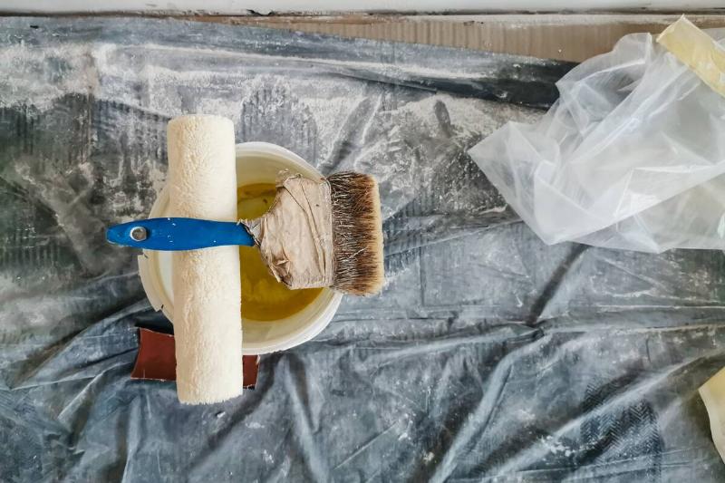 top-view-of-construction-worker-desk-with-things-f-2025-01-10-02-16-28-utc Drop cloth under paint supplies.