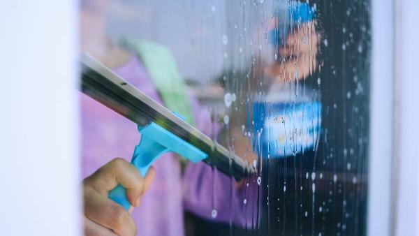 Woman cleaning her window.