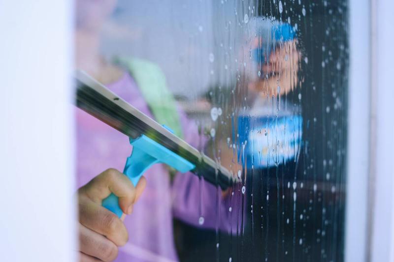 woman-cleaning-window-2025-03-15-19-37-52-utc Woman cleaning her window.