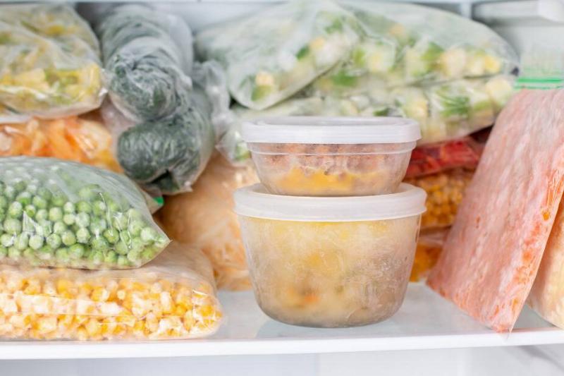 Bags and containers of food in a freezer