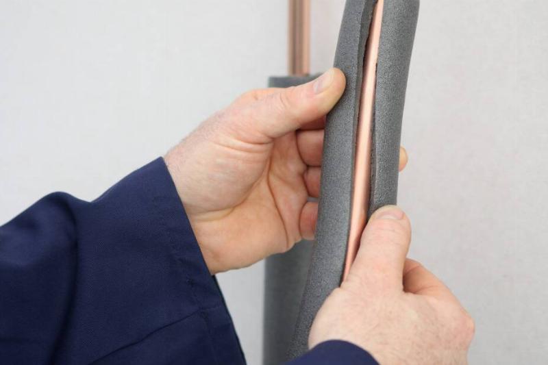 Hands putting noodle on pipe.