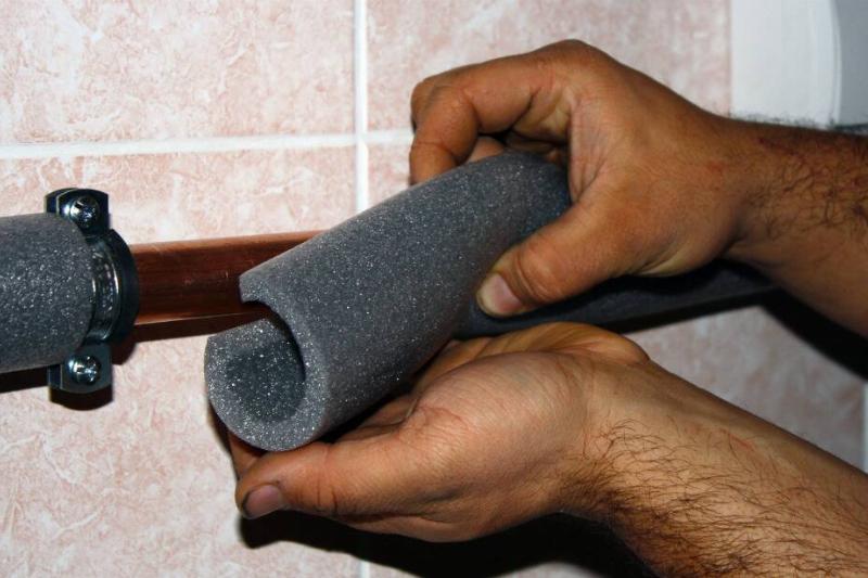 Hands putting noodle on pipe.