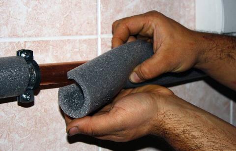 Hands putting noodle on pipe.