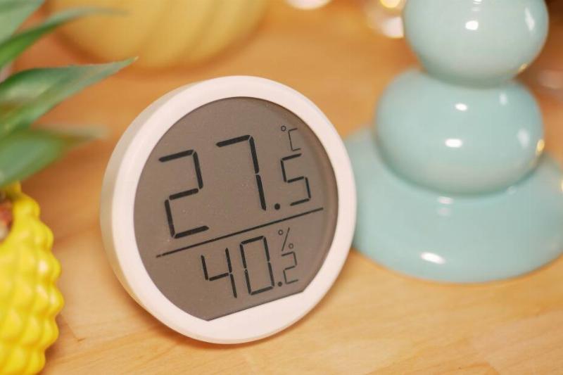 A thermostat showing the temperature and humidity.