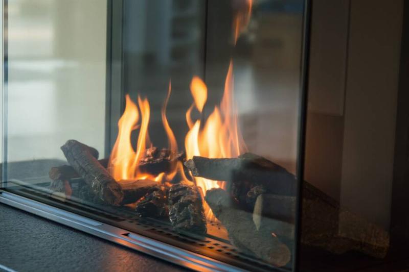 Gas fireplace behind glass door. 