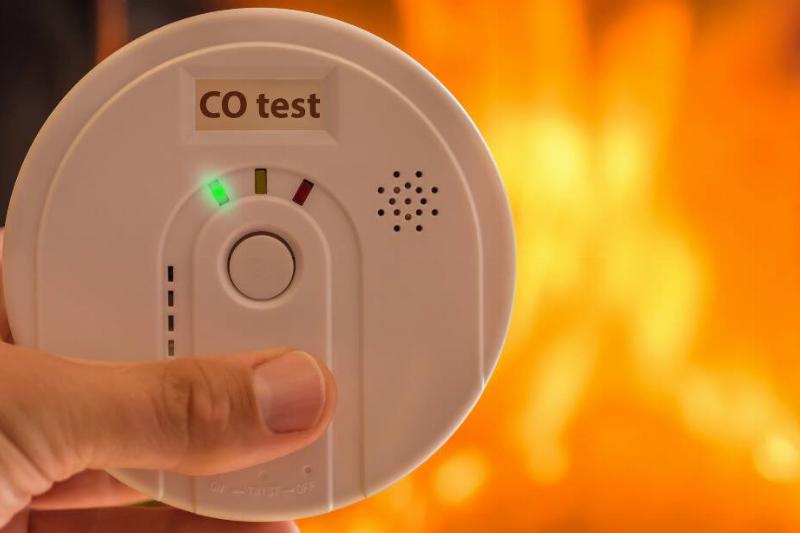 Carbon monoxide detector in front of a fireplace. 
