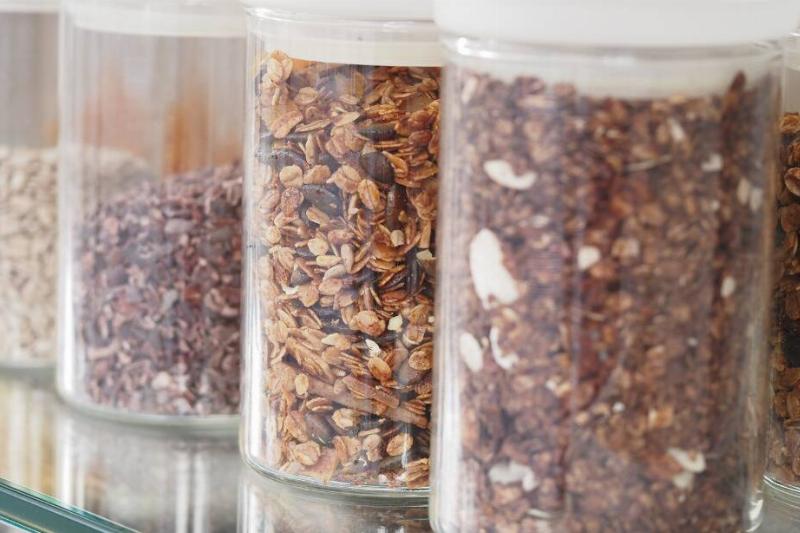 Cereal sealed up in glass jars in a pantry. 