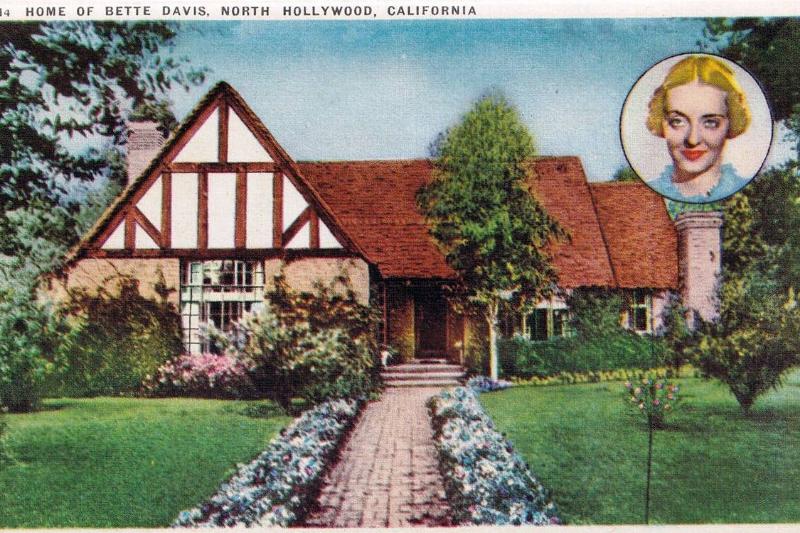 Vintage souvenir postcard published in 1940 with portrait of actress diva Bette Davis and her handsome Tudor style mansion.