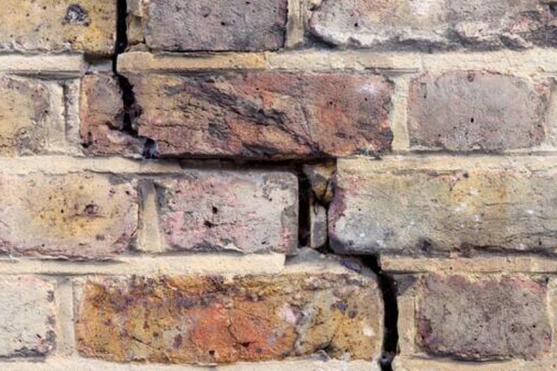 Missing mortar in brick fireplace. 