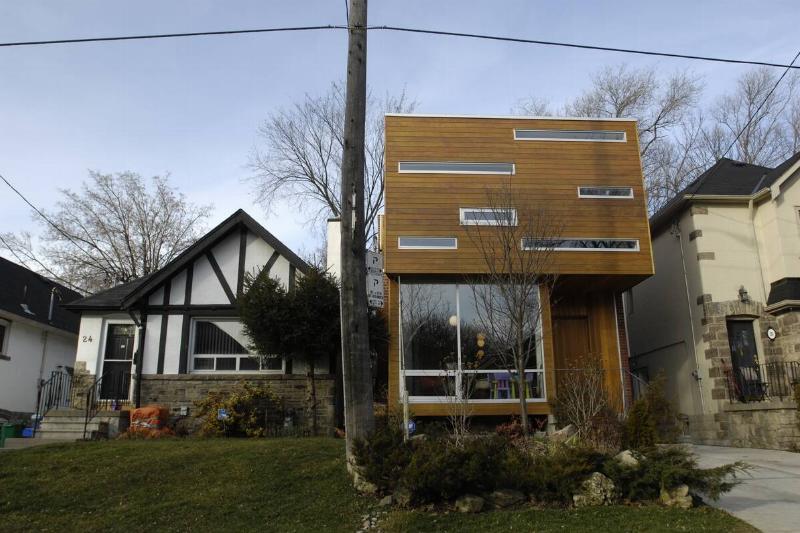 A contemporary house beside a tudor house.