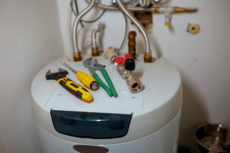 Water heater with tools on top. 