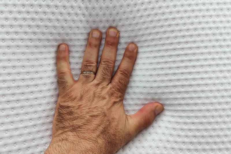 Hand pressed into memory foam pillow.