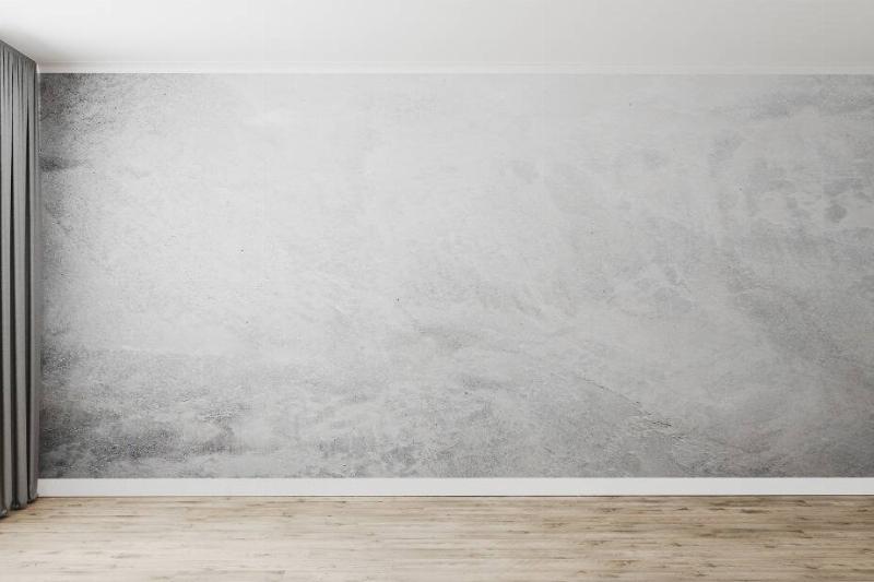 Lime-washed wall in empty apartment.