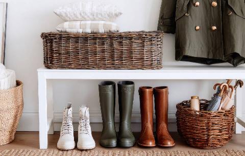 Bench in entryway with winter boots and jacket.