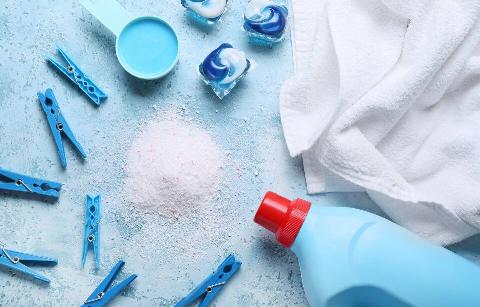 Laundry products on blue shelf. 