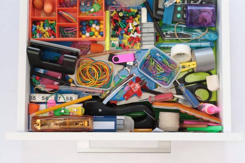 Items grouped together in messy drawer.