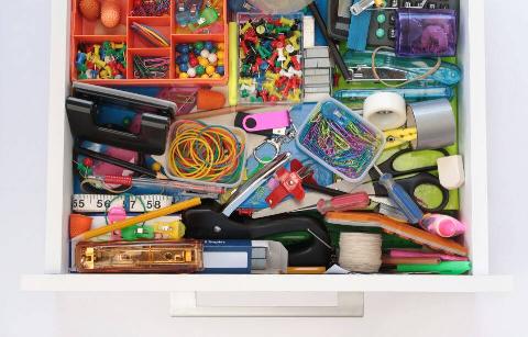 Items grouped together in messy drawer.