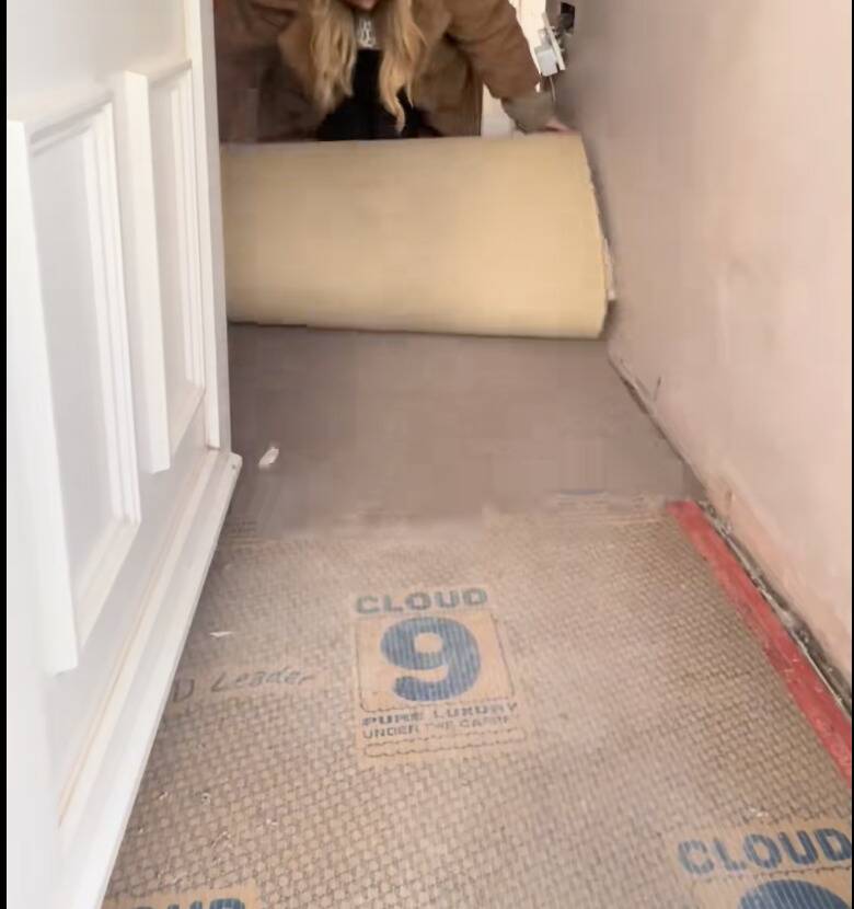 Tara pulling up the carpet.