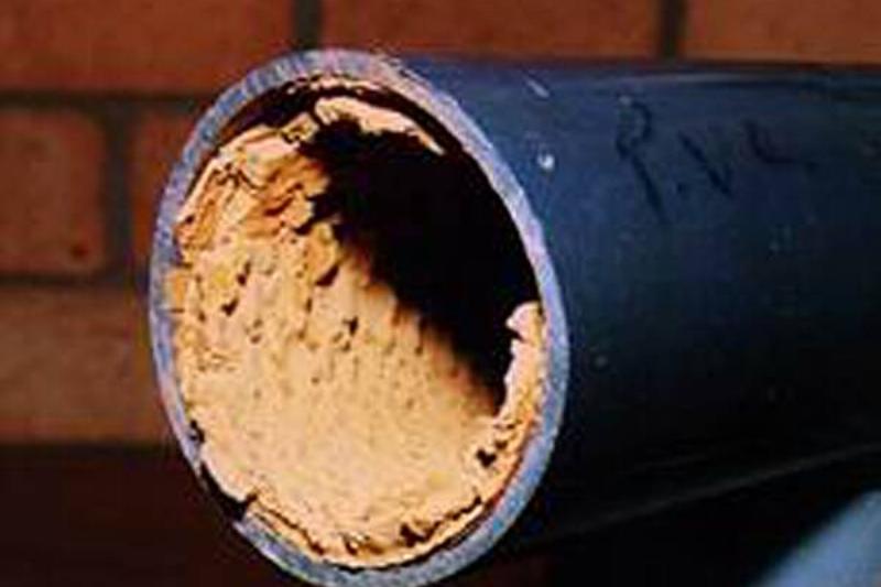 Limescale buildup inside pipe. 