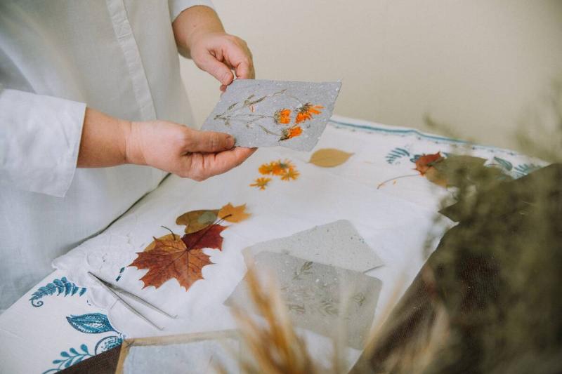 Woman doing pressed flower art.