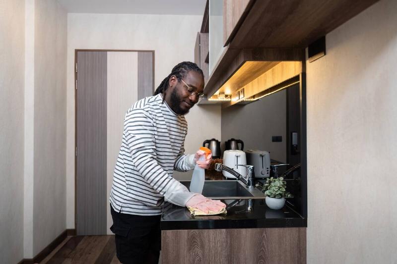 Man cleaning his kitchen counter. 