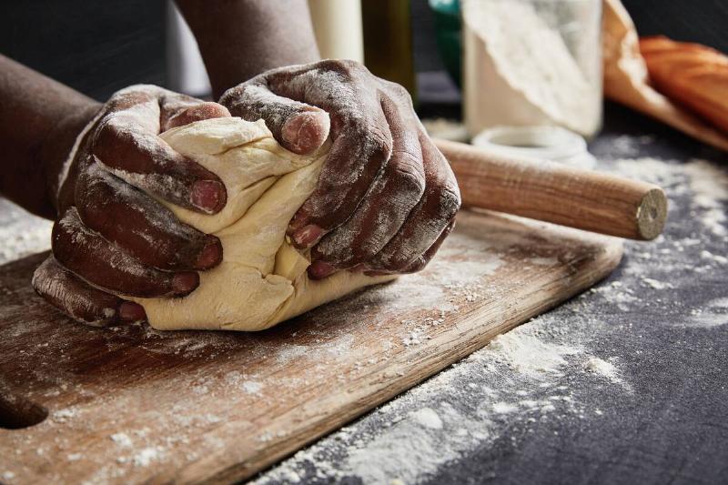 Man kneading dough. 