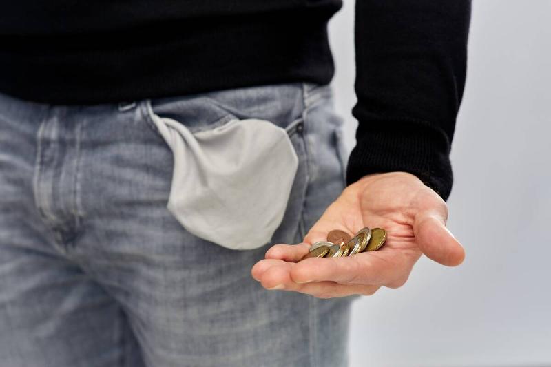 Man pulling coins out of pocket.