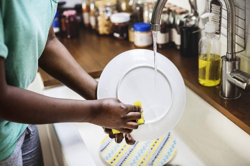 A man washing dishes.