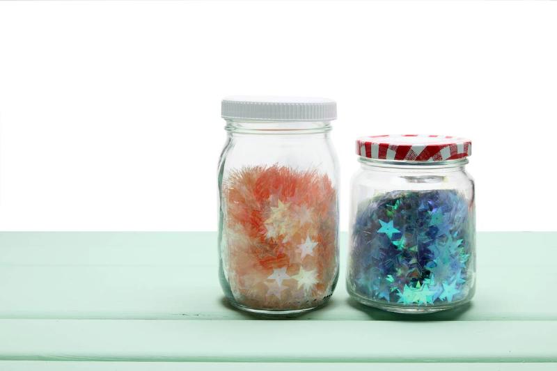 Glitter craft supplies in two glass jars.