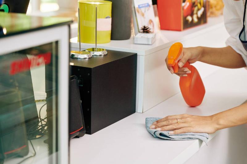 Cleaning counter with disinfectant and a rag. 