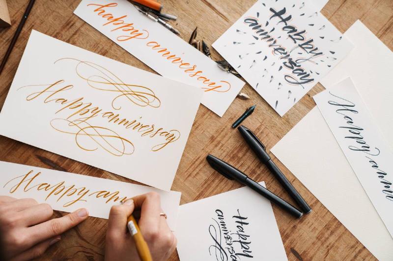 Person practicing hand lettering.