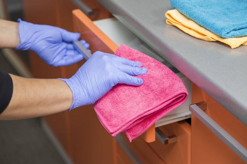 Woman cleaning a drawer.