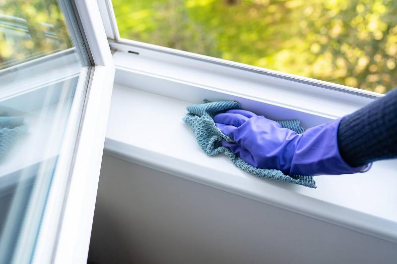 Cleaning window sill. 