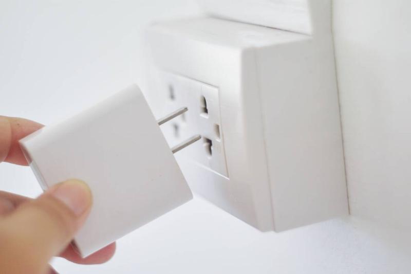 Unplugging a plug from the wall. 