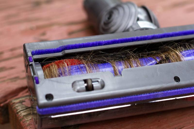 Vacuum cleaner brush roll wrapped in hair.