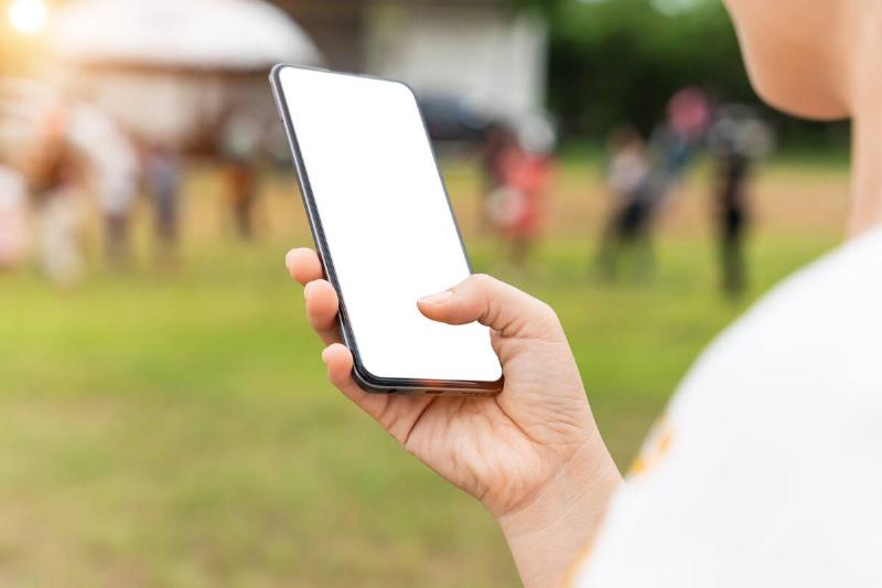 A person using a smartphone outside.