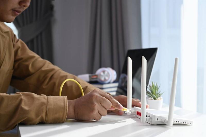 Man unplugging WiFi router. 