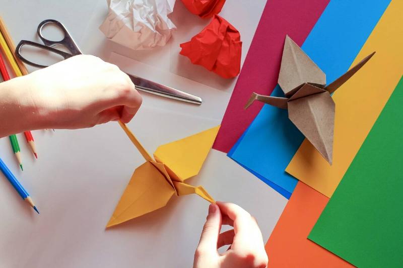 Persona making origami crane.