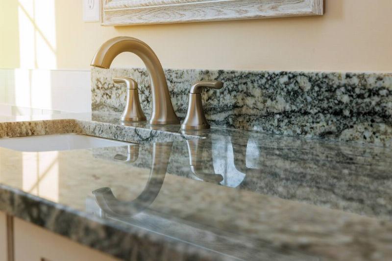 White marble bathroom countertop with a sink.